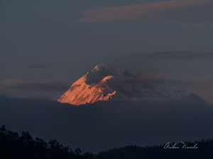 An incredibly beautiful photo of the Trisul range in the Himalayas. The setting sun's final rays of the day bathe the range in an ethereal view, that is supremely immersive. Grab a print now!