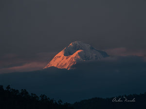 An incredibly beautiful photo of the Trisul range in the Himalayas. The setting sun's final rays of the day bathe the range in an ethereal view, that is supremely immersive. Grab a print now!
